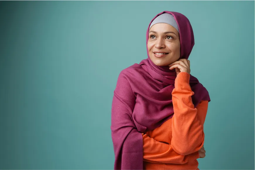 A smiling professional in a magenta hijab